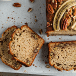 Gordon Ramsay banana bread sliced with pecans and banana topping