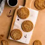 chewy pumpkin spice cookies stacked on wood board