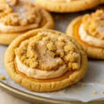 Crumbl Pumpkin Pie Cookies stacked on a fall-themed table