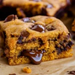 Fudgy Pumpkin Bars with Chocolate Chips on rustic table