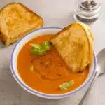 Copycat Panera Tomato Soup Recipe served with grilled cheese