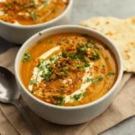 Curried Sweet Potato Soup in a rustic bowl with toppings