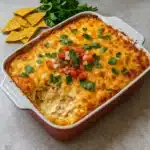 Easy Mexican White Trash Casserole baked with melted cheese and cilantro garnish