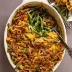 green bean casserole in white dish with crispy topping