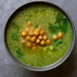 Green Goddess Herb Soup in a rustic bowl with creamy swirl and chickpeas