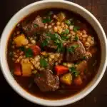 Hearty Beef and Barley Soup served hot in a rustic bowl
