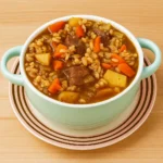 Instant Pot Beef & Barley Soup in bowl with steam