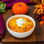 Pumpkin Chicken Chili in a bowl with fall toppings