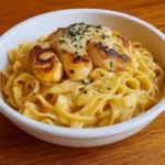 Chicken with buttered noodles in ceramic bowl