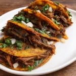 Crock Pot Birria Tacos served with consommé and fresh garnishes