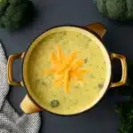 High-Protein Broccoli Cheddar Soup served in a rustic bowl
