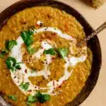 red lentil dahl served with naan in a rustic kitchen