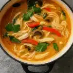 Simple Thai Chicken Soup in bowl with fresh toppings