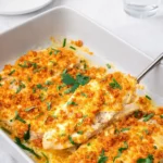 Baked Caesar Chicken with crispy topping and parsley garnish in a casserole dish