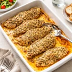 Garlic Parmesan Chicken Bake in white baking dish with herbs