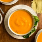 Healing Slow Cooker Carrot Soup in a bowl with garnish