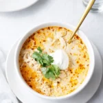 High Protein White Chicken Chili in bowl with toppings