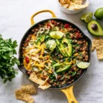 20-Minute Turkey Taco Skillet in cast iron pan with toppings