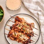 Bang Bang Chicken Skewers brushed with sweet and spicy sauce