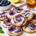 blueberry cheesecake cookies stacked with creamy center
