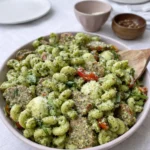 Chicken Sausage Pesto Pasta served with fresh basil and parmesan