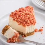 Instant Pot Strawberry Crunch Cheesecake slice with crumble topping