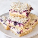 keto blueberry lemon cheesecake bars sliced on a plate