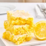 Lemon Cake Mix Brownies with glaze on wooden board