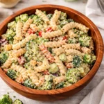 ranch pasta salad on picnic table with veggies and creamy dressing