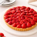 Strawberry Custard Tart on rustic table with fresh strawberries