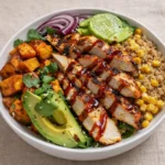 BBQ Chicken and Roasted Sweet Potato Bowls served in a rustic ceramic dish