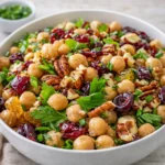 Cranberry Walnut Chickpea Salad with orange vinaigrette in a rustic bowl