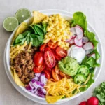 Ground beef taco salad with toppings and dressing