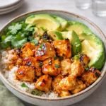 A delicious Hot Honey Chicken Bowl with glazed chicken, broccoli, and sweet potatoes.