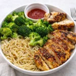 Spicy Garlic Chicken and Broccoli Noodle Bowls in a ceramic bowl