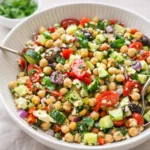 10-Minute Mediterranean Chickpea Salad in a white bowl on a wooden table