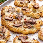 Roasted Cheesy Cauliflower Mushroom Steaks with melted cheese and herbs.