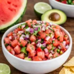 A colorful bowl of Chilled Watermelon Salsa with tortilla chips.