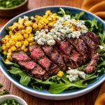 A vibrant Grilled Balsamic Steak Salad with sliced beef and gorgonzola.