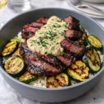A vibrant Grilled Steak Bowl with Sauce and Grilled Zucchini Bliss on a wooden table.